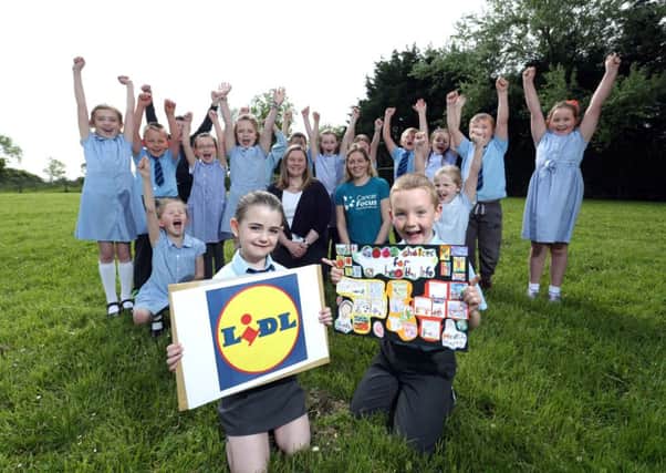 Primary 3 Teacher Elaine Barton with Niamh McDaid Cancer Prevention Officer Cancer Focus Northern Ireland and pupils from St Marys Primary School. Picture by Brian Thompson/Presseye