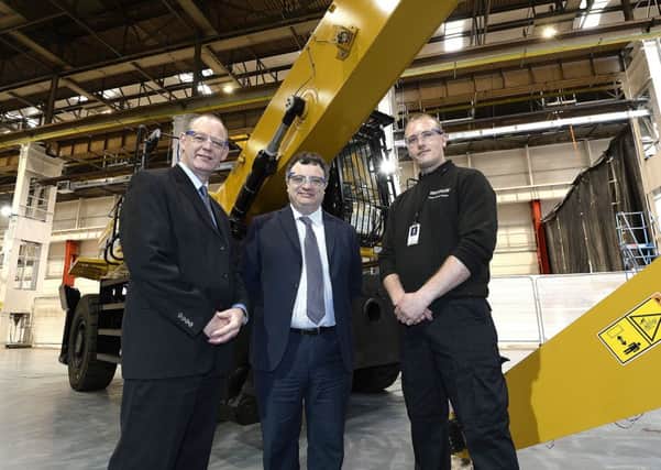 Employment and Learning Minister Dr Stephen Farry (centre) visits Caterpillar in Larne to see first-hand the training being delivered for the companys material handler project. Also pictured are Robert Kennedy, Operations Director for Caterpillar NI, and Paul Wilson, team lead for the material handler project.  INLT 24-675-CON