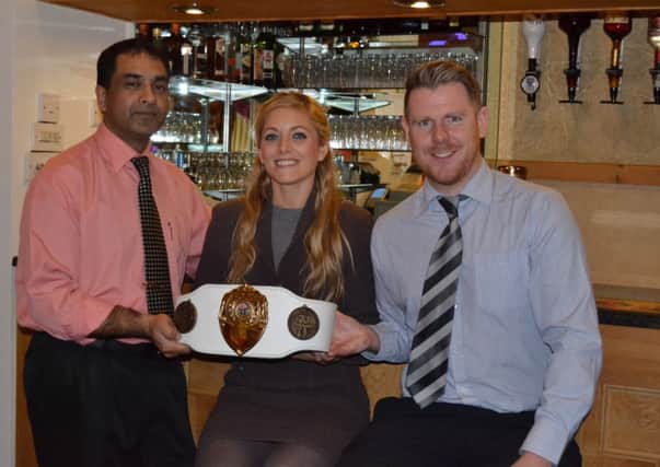Northern Ireland champion Karla McAviney and her husband Kevin recently called into Edenderry's Bengal Tandoori to show off her kickboxing belt to friend and fan Amir Hamja (left).INPT22-148

PTMARTIALARTS14