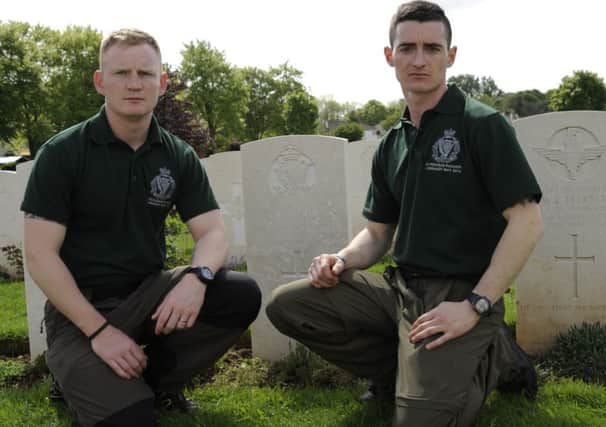 Sergeant Lorimer, 1 Royal Irish, and Sergeant Aicken, 2 Royal Irish, both from Ballymena, at the graveside of Rifleman Crawford, who was the son of John and Elisabeth Crawford of Ballymena. RUR.