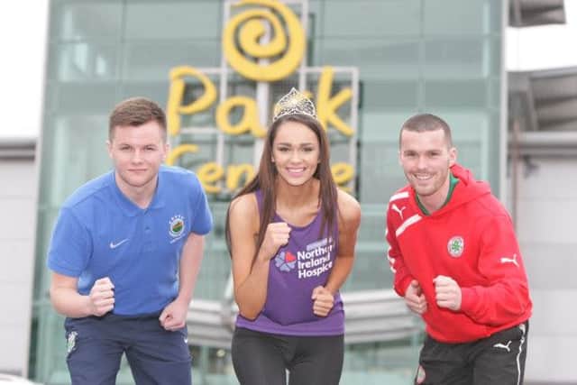 At the Park Centre promoting the Northern Ireland Hospice Westlink Between the Bridges, walk run or jog is Miss Northern Ireland 2014, Rebekah Shirley with Linfield and Cliftonville players Niall Quinn and    Martin Donnelly. INBM24-14 S