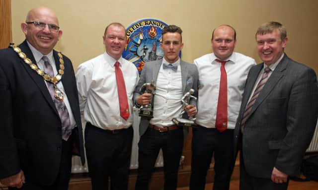 MINE'S A DOUBLE. Aidie McCook (centre), who received the Glebe Rangers Res Manager's Player of the Year award and Player's Player of the Year trophy, pictured along with team Manager Allan Bartlett and Assistant Manager Ivan Campbell on Saturday night. Also included are Guests Mayor Cllr John Finlay and MLA Mervyn Storey.INBM24-14 065SC.