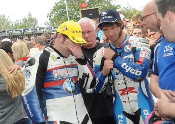 Michael Dunlop talks with Guy Martin after winning the Senior TT on the Isle of Man and learning that his brother William had a crash. PICTURE BY STEPHEN DAVISON