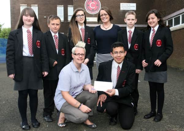 Lisa Kirkwood of the Race for Life Cancer Research UK is pictured receiving a cheque from the pupils of Ballee High School, money raised by the pupils in support of teacher Miss J Kyle who will be taking part in the race. Included is teacher Mrs. Fiona Crossey. INBT24-217AC