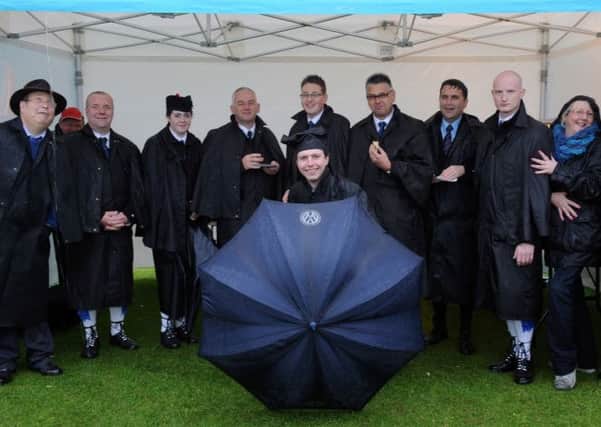 Ray Hall, chairman of the Royal Scottish Pipe Band Association Northern Ireland (left), dodging the rain with local band members including Pipe Majors John Fittis and Grahame Harris, Major Sinclair Memorial Pipe Band, and Pipe Major Alistair McCleery, Ballydonaghy Pipe Band. INLT 24-678-CON