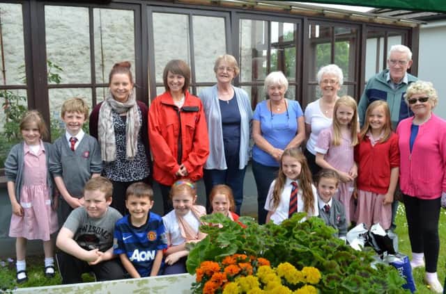 Rita Murray, Stanley Carson, Lily Gault, Pat Granger, Lorraine Bell (Wesley Court residents), Cathy Taylor (Wesley Court supervisor) Abbie Johnston and Miss Montgomery (school Eco-coordinator) and the Model Primary P4 Growing Club. INCT 24-741-CON