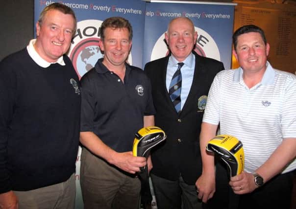 Peter O'Hara Chairman of competition charity HOPE03 (left) with winners Jimmy Robinson and Gordon Goodfellow and their prizes. Also pictures is Paul Banford
Captain of Rockmount Golf Club (second right).