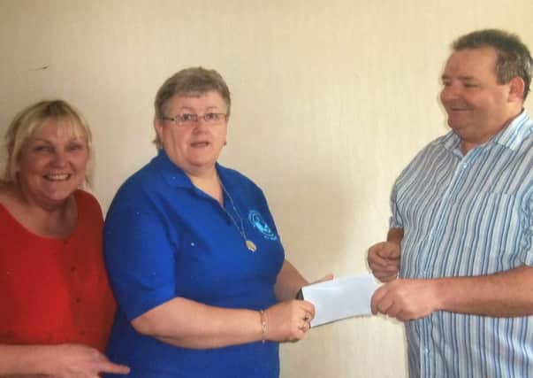 Josie Ferris of the Hibernian Club Linsburn presenting a cheque to Anita Murray of the The Compassionate Friends charity. Onlooking is Collette McShane.