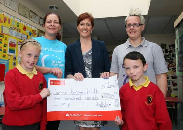 Abbie Sweetlove and Bradley Greer from Ballykeel PS along with principal Mrs. S. Sheeran, present a cheque for £500 to Saranne Bartley and Lisa Kirkwood from the Race for Life Cancer Research UK, proceeds of a non uniform day. INBT24-219AC