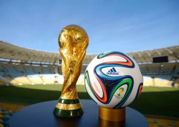 The Jules Rimet trophy and the new Brazuca football which will be used at this month's World Cup.