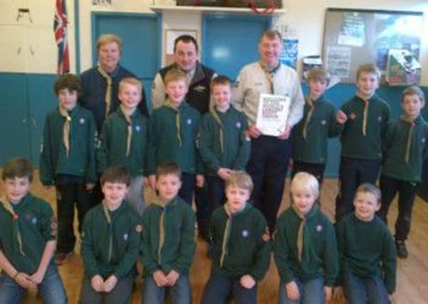 Cubs from 1st Annahilt Scout Group congratulate their leader Alan Jess with his leadership Wood Beads