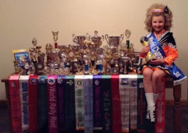 Irish dancer Holly Jamison pictured with her impressive trophy haul.  INLT 25-679-CON