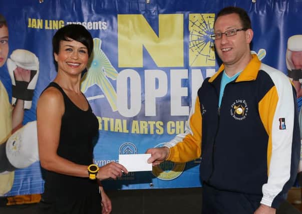 Estelle Wallace of Shrink Fitness presents a sponsorship cheque to Ernie Johnston of Ballymena Jan Ling Club for the International Martial Arts team event, featuring teams from England, Scotland, Republic of Ireland and Northern Ireland, which will be held in Ballymena North in September. INBT 25-174CS