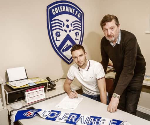 Neil McCafferty signs on the dotted line for recently appointed Coleraine F.C. General Manager Hunter McClelland. PICTURE BY DEREK SIMPSON