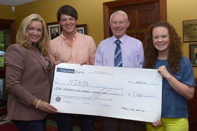 Luke and Gina Woods son and daughter of the late Trevor Woods and Trevor's father Noel presented a cheque for £1100:00 part proceeds from the Woody & Spla Golf Day at Banbridge Golf Club to Jo-Anne Dobson MLA, Volunter Press Officer for the Northern Ireland Kidney Patients Association © Edward Byrne Photography INBL1424-254EB