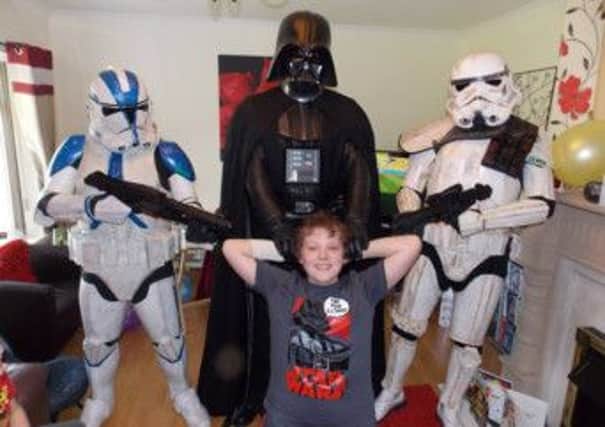 Star Wars fan Scott Kelley receives a surprise visit from Darth Vader and the Stormtroopers.  INCT 25-733-CON