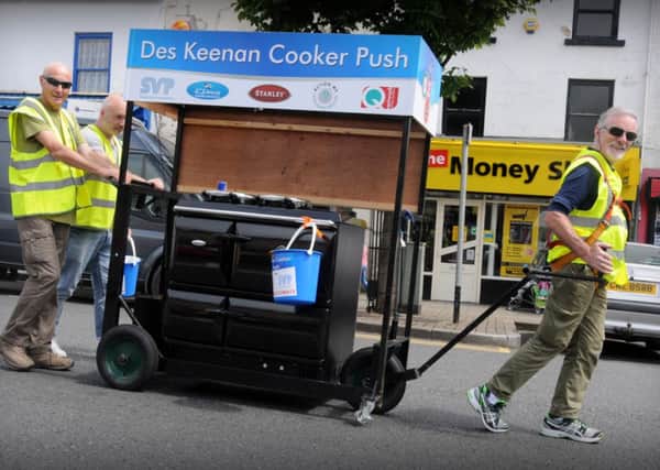 A smiling Des Keenan as he makes his way down the main street of Cookstown during the final part of his 40 mile Cooker Push challenge in aid of SVP and Action MS.INMM2514-365