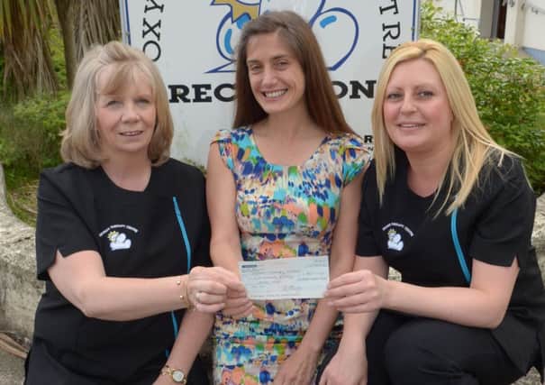 Juliane Keane (centre) presenting a cheque for £460 to Linda Boyd and Vickie Shaw o f the Oxygen Therapy Centre. Juliane took part in the Run Her Coastal Challenge to raise the money. INLT 25-353-PR