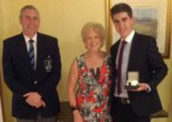 Dunmurry Golf Club captain Lawrence Patterson and wife Mary with Captain's Day winner Christopher Morgan.