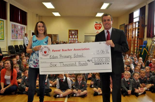 Claire Brown, chairperson of Eden Primary School PTA, handing over a cheque for £6000 to the principal Dr Martin Sheeran.. INCT 25-101-GR-Eden PS