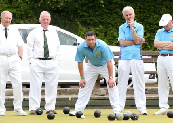 Lisnagarvey captain Neil Mulholland inspects the bowls during his sides irish Senior Cup clash with Shaftesbury. Pic: Darren Kidd / Presseye.com