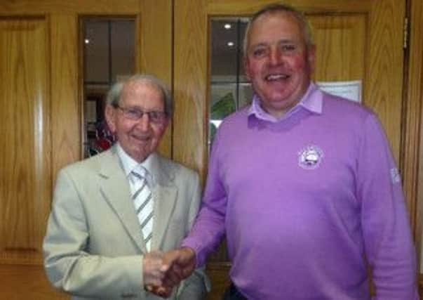 Prof. Jimmy Todd (left) is Rockmount's oldest member having celebrated his 90th birthday last month. He's still playing golf every Tuesday morning. Here he's congratulated on his birthday by ex-captain Robert Patterson.