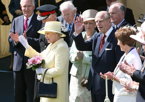 Her Majesty The Queen and Prince Philip wave to the crowds during their 2007 visit to Coleraine.