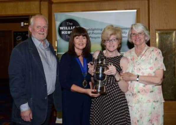 Ann Molloy receiving The Haldene Butler Memorial Cup on behalf of her husband Stephen from Kate Smith, the Trusts President, together with Stephens Mother, Maureen and Bob Harper from Belfast Lough Sailability.  INCT 26-724-CON