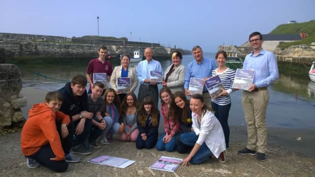 Launch of the guides in Ballintoy Harbour 18th June 2014. Pictured are William Lynn and Nicole Sloane with their kids from Foyle College along with CCGHT Chairman Bill Harpur (OBE), Cllr Sandra Hunter (Moyle District Council), Liz Wallace (Western Education and Library Board's Magilligan Field Centre) and Peter McCaughan from Impact Design and Print in Ballycastle. INBM26-14 S
