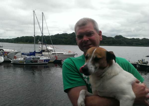 Darren Robb with his beloved Tóibín, and the Stoney B, which he intends to sail around Ireland, in the backdrop.