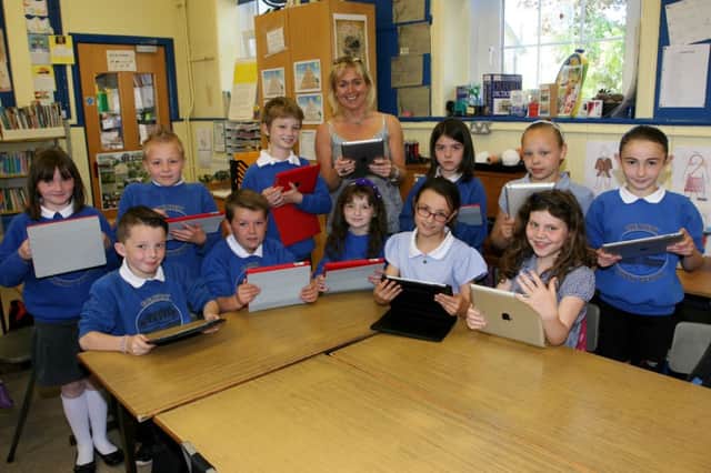 Primary 5 pupils along with teacher Mrs. P. Davidson using their iPads at Creavery PS. INAT26-403AC
