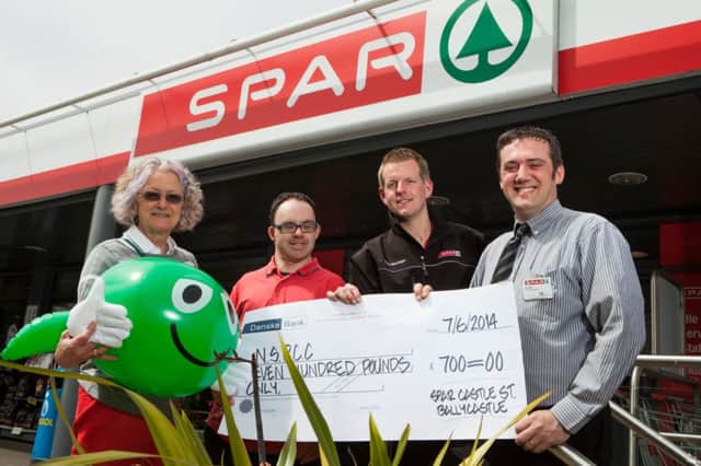 Sally Andrew, Childline Support worker from NSPCC, is presented a cheque from SPAR Ballycastles Staff Declan Boyle, Lindsey Milling and Alan Troy, SPAR Ballycastle Store Manager.INBM26-14