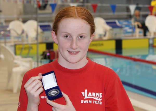 Carnmoney girl  Danielle Hill shows off one of the many medals she has won as a member of Larne Swimming Club.