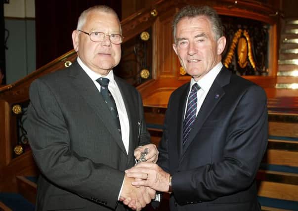 Sam Moody pictured receiving his award from RNLI Chairman Charles Hunter-Pease. Photo by Colin Watson. INLT-26-703-con