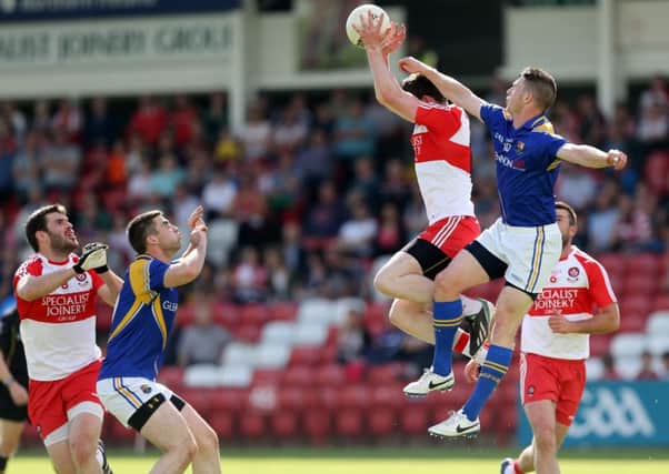 Derry's Emmet Bradley wins the ball as Longford's Michael Quinn challenges while Mark Lynch (Derry) and Kevin Diffley (Longford) await the outcome