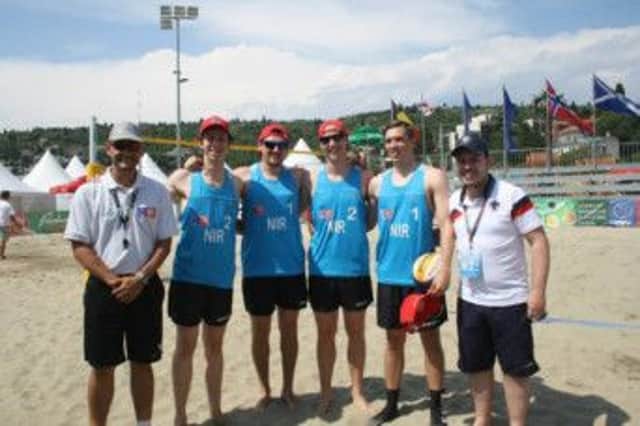 The NI men's beach volleyball team are pictured with their coaches during the Olympic qualifying event in Slovenia.