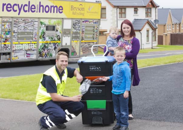 Gareth Townsley (left) from Bryson Recycling with Oliver Shields, Danielle Shields and Ethan Shields from Aylesbury Lane near Glengormley as they put Bryson Recyclings new Wheelie Box to test.