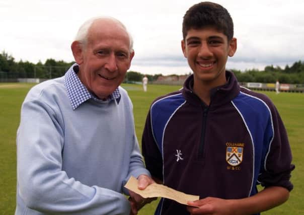 Coleraine's Varun Chopra receives the Danske Bank player of the round award from former North West and Strabane legend Paddy Gillespie.