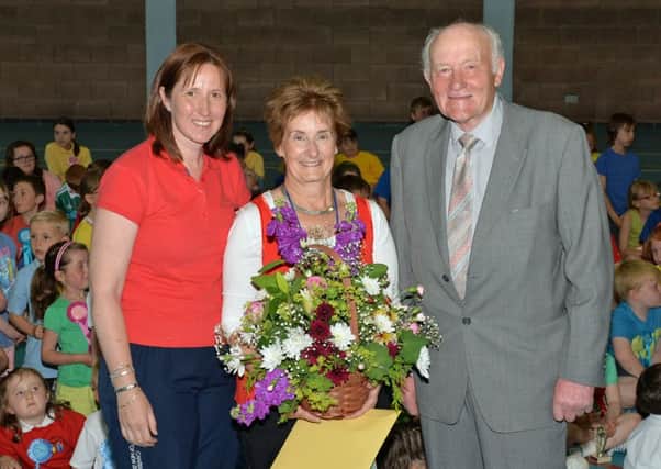 Mrs Parker (centre) is pictured on her retirement after serving 27 years as a teacher in Glynn Primary School with school principal, Miss Diane Hawthorne and chairman of he school Board of Governors, Roy Beggs MLA. INLT 26-020-PSB