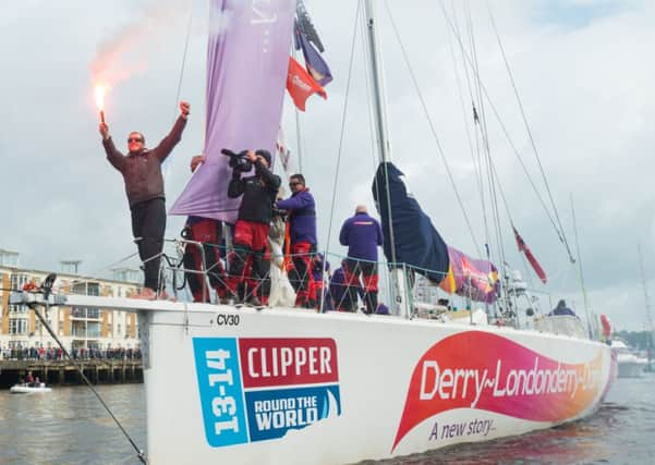 A triumphant skipper Sean McCarter lights a flare in celebration as the Clipper yacht, Derry-Londonderry-Doire which won the New York to Derry leg of the round the World Yacht Race arrives home on the River Foyle. Picture Martin McKeown. Clipperrace.com