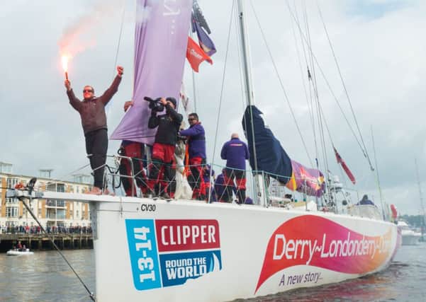 A triumphant skipper Sean McCarter lights a flare in celebration as the Clipper yacht, Derry-Londonderry-Doire  which won the New York to Derry leg of the round the World Yacht Race arrives home on the River Foyle. Picture Martin McKeown. Clipperrace.com