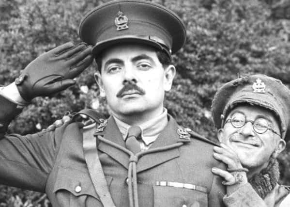 Rowan Atkinson as Captain Edmund Blackadder (left) with Tony Robinson as Private Baldrick, promoting the series of Blackadde set during the First World War. Photo: Martin Keene