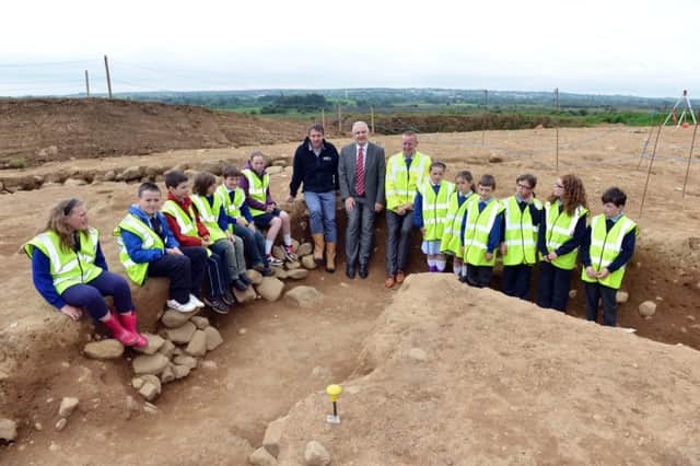 Children from St Joseph's PS, Dunloy, Cloughmills PS, St Brigid's PS, Cloughmills and Knocknahollet PS pictured with Regional Development Minister, Danny Kennedy, Paul Logue, Senior Archaeologist, Department of Environment (left) and Colin Hutchinson, Department for Regional Development at an archaeological dig on the £65 million A26 Frosses Road scheme.  As part of the dig an early medieval (approximately 600-1200AD) souterrain consisting of a number of underground passages was uncovered.  

Pic: Stephen Hamilton, Press Eye