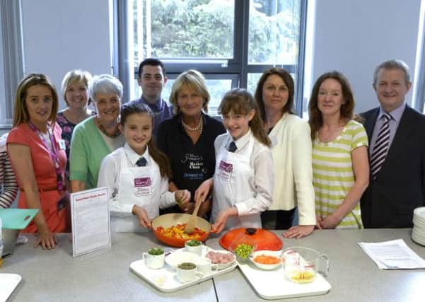 Celeb Chef Jenny Bristow assisted by Competition winners Lucy Wan and Emma Telford prepare a meal for the students, included is CLIC Sargent Communications Manager Christine Crawford,Down & Armagh CLIC Sargent Fundraising Manager Fiona McCann, Home Economics Technician Noreen Hazley, Head of HE Kay Francey, HE Teacher Adam Grimley, CLIC  Sargent NI Appeal Director Teresa Sloan, Teacher Lynne Elliott and Principal Raymond Pollock © Edward Byrne Photography INBL1426-205EB