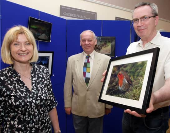 LAUNCH. Pictured at the Opening of the Ballymoney Photographic Club's annual Exhibition in Ballymoney Town Hall on Monday night are Cultural Services Officer Margaret Edgar, Mac Pollock, Arts Committee Chairman and Chairman of the B.P.C. Leonard Ferguson.INBM27-14 015SC.