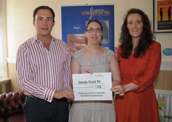 Elaine Bull from Doula Trust NI is presented with a £102 cheque by Dr. Graeme Ritchie and Zoe Brook from Carrick Chiropratic. The money was raised by means of donations from patients.  INCT 26-200-AM