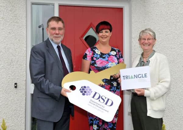 Minister for Social Development Nelson McCausland hands over keys to Lucinda Smyth, the first tenant in Triangle Housing Associations new housing scheme in Maybin Park in Kells, picture with Noeleen Diver, Chair of Triangle Housing Association.