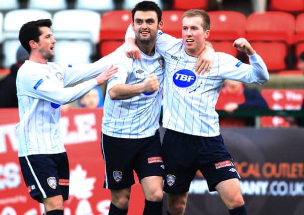 Coleraine's Stephen Dooley (right) celebrates with Eoin Bradley and Gareth Tommons after scoring last season for the Bannsiders.