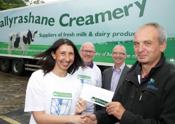 NICE CREAM. Emma Birrell, Company Secretary at Ballyrashane Creamery, who are the new sponsors of the Riada Fun Run, pictured on Thursday presenting a sponsorship cheque to Sports Development Manager John Fall with Kenny Bacon and Brian Edgar from the organising Committee, Springwell Running Club looking on.INBM27-14 060SC.