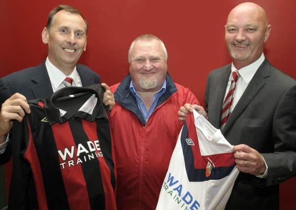 New Banbridge Town chairman Stephen Radcliffe (right) is in optimistic mood after the AGM. He has announced his hopes for his time in the chair . Also pictured are club President Andrew Cully (left) and Annesley Renshaw from sponsors Wade Training. INBL40-206EB